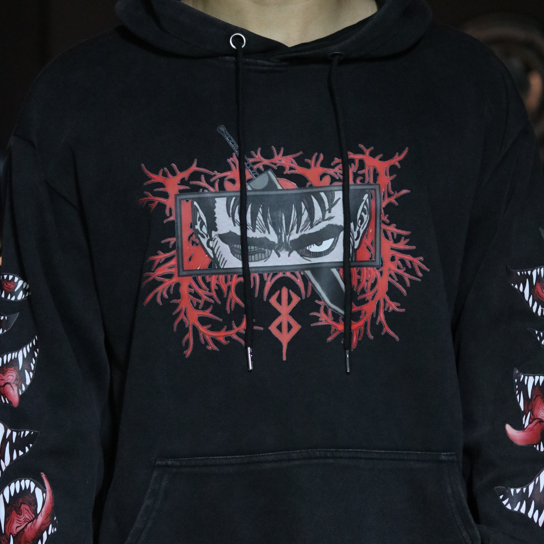 Black hoodie with red and white graphic design on a dark background