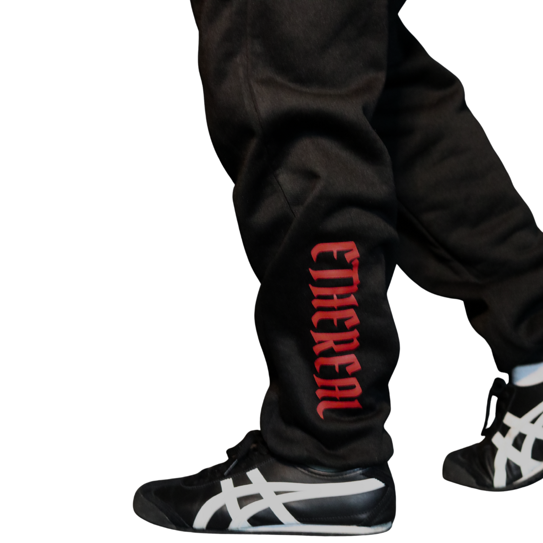 Side view of Ethereal Berserk joggers showing embroidered crest and tapered fit.