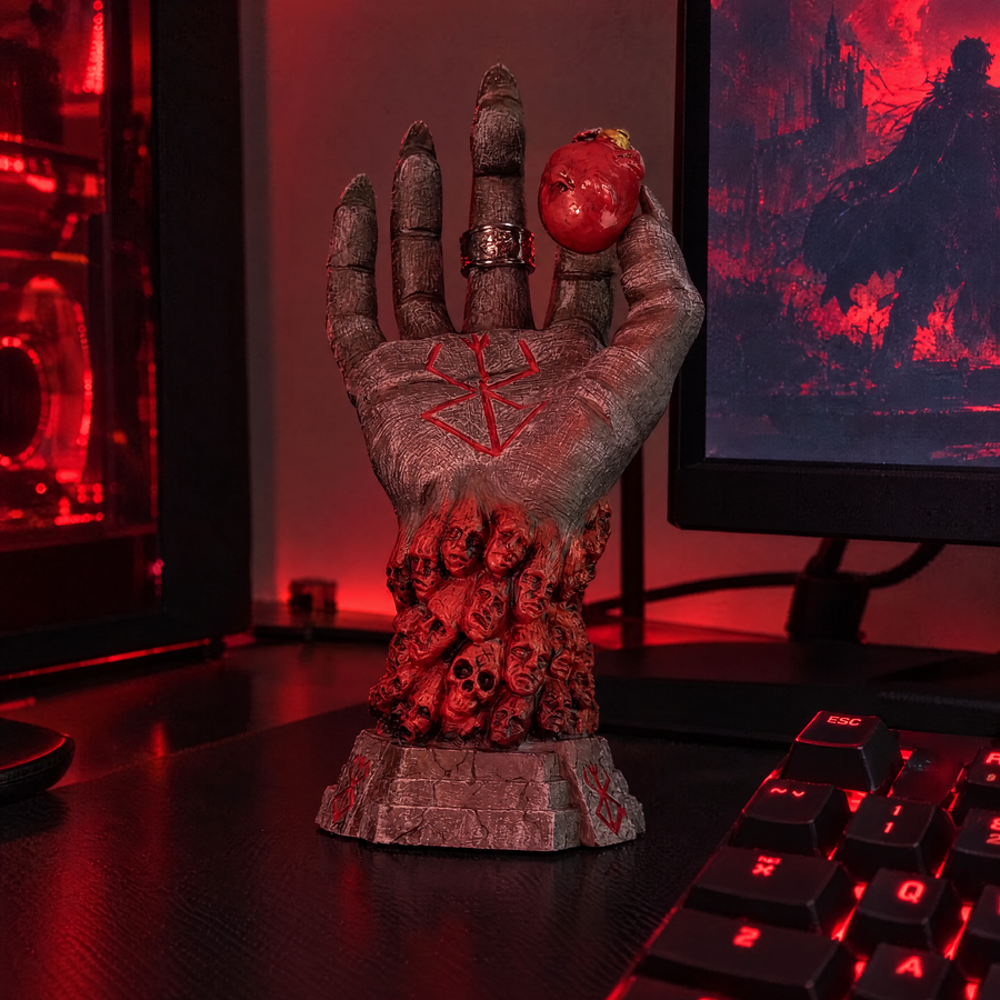 God Hand ornament on a gaming desk holding a ring
