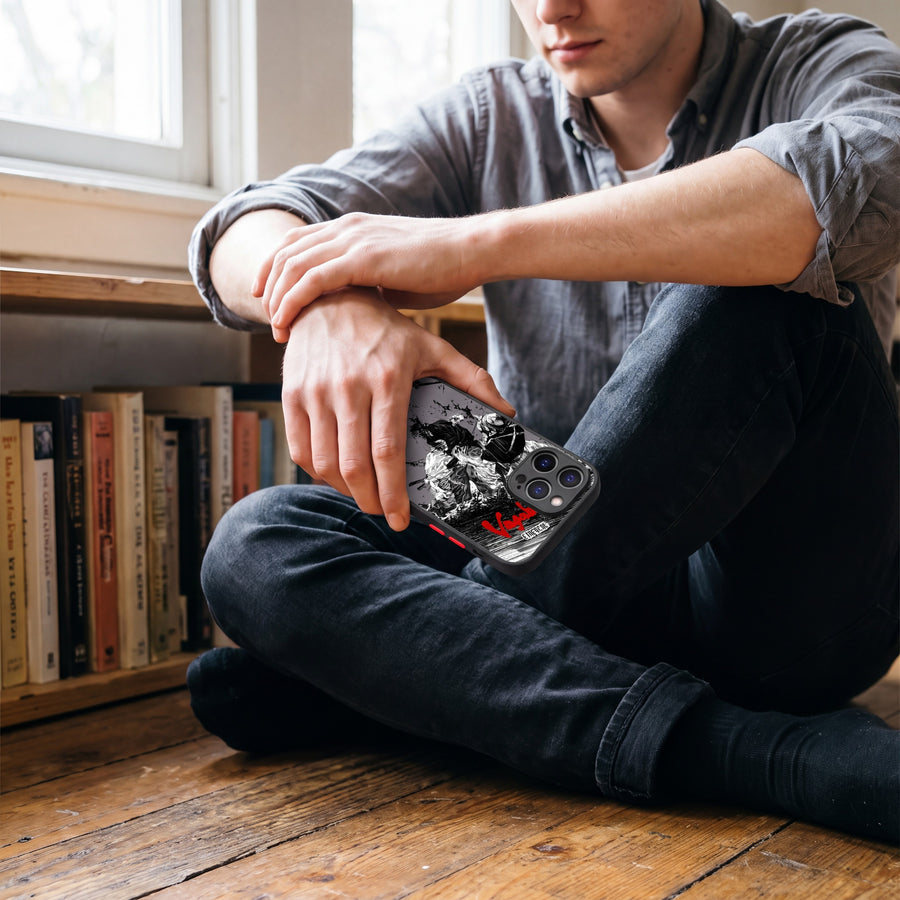 Vagabond Blood and Ink phone case held beside a bookshelf